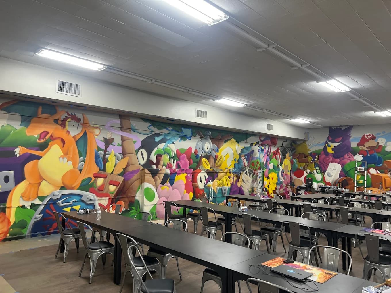 Pokémon mural and tournament play area at Collector's Cove